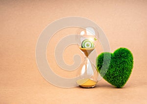 Environment sustainability, time and responsibility concept. Target of restoring our earth. 3d green target icon in hourglass and