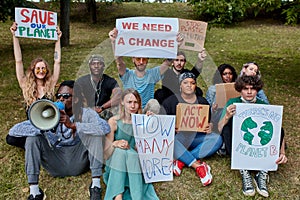 Environmental activists hold placards and chant slogans during a demonstration