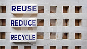 Environmental awareness and educational concept. REUSE, REDUCE and RECYCLE written on wooden blocks