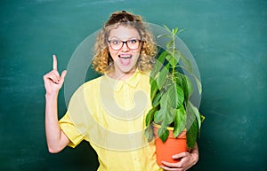 Environmental education. happy student girl with plant at blackboard. teacher woman in glasses at biology lesson. school