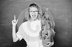 environmental education. happy student girl with plant at blackboard. teacher woman in glasses at biology lesson. school