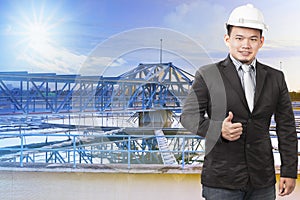 Environmental engineering man standing in front of waterworks photo