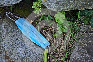 Environmental pollution with disposable surgical face mask during COVID-19. Thrown away or lost blue face mask among stones