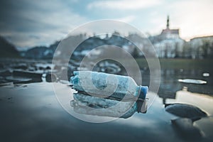 Environmental pollution: plastic bottle on the beach, urban city