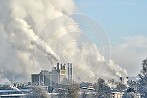 Environmental problem of pollution of environment and air in cities. Smoking industrial zone factory chimneys. View of