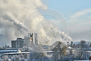 Environmental problem of pollution of environment and air in cities. Smoking industrial zone factory chimneys. View of