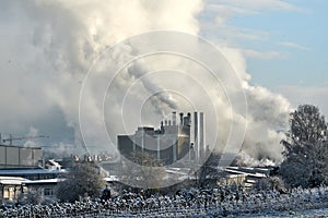 Environmental problem of pollution of environment and air in cities. Smoking industrial zone factory chimneys. View of