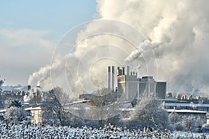 Environmental problem of pollution of environment and air in cities. Smoking industrial zone factory chimneys. View of