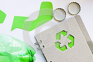 Environmental protection, ecology and recycling concept, recycle sign, notepad and garbage on white background