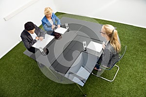 Environmentalists Sitting At Desk In Office