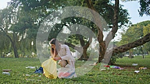 Environmentally conscious woman cleaning park. Volunteer focuse trash collection