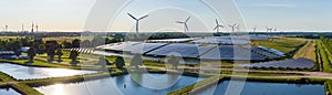 Environmentally friendly installation of photovoltaic power plant and wind turbine farm situated by landfill.Solar panels farm bui