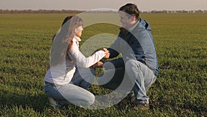 Environmentally friendly sprout. farmer and business woman holding in their hands green seedlings of wheat working in