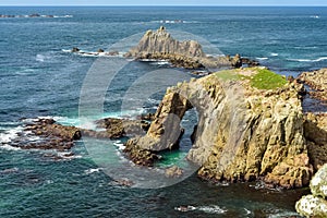 The Enys Dodman Arch at Land`s End, a headland and holiday complex in western Cornwall, England