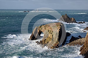 Enys Dodman, The armed knight rock and Longships Lighthouse Lands End Cornwall, UK 