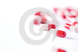 Enzyme capsules on white background. Red pills. Copy space.