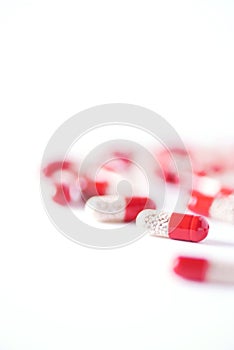 Enzyme capsules on white background. Red pills. Copy space.