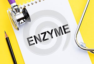 ENZYME word write on medical notebook with stethoscope