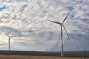 Eolian field and wind turbines farmon a cloudy day