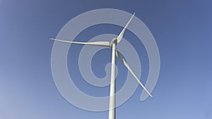 Eolic turbine isolated on a blue sky backgroudn, wind energy