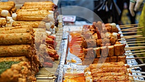 Eomuk, Korean street food. Fried fish cake stick with red sauce