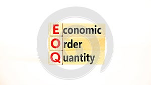 EOQ economic order quantity symbol. Concept words EOQ economic order quantity on wooden blocks on a beautiful white table white