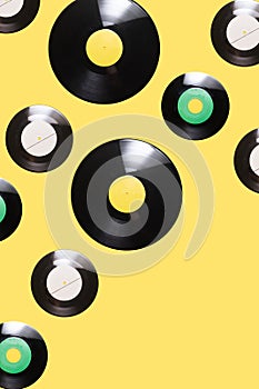 EP and two LP vinyl records inspired arrangement of funky pattern against illuminating yellow background