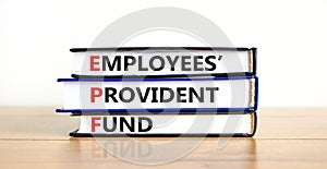 EPF, employees provident fund symbol. Books with words `EPF, employees provident fund`. Beautiful white background, copy space.