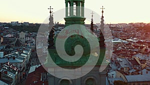 Epic aerial cinematic shot of sunset on authentic spires of Dominican Cathedral, Assumption church in Lviv, Ukraine.