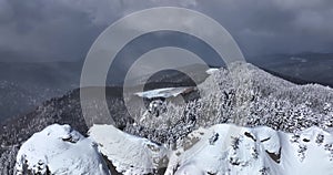 Epic aerial over cinematic mountains peaks on a sunny snowy winter day