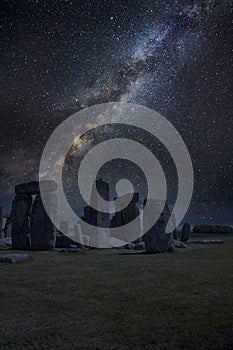 Epic digtial composite image of ibrant Milky Way over ancient monolithic standing stones in landscape