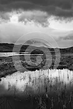 Epic dramatic  black and white landscape image of Loch Ba on Rannoch Moor in Scottish Highlands on a Winter morning