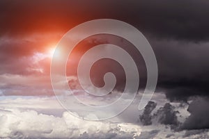 Epic dramatic storm dark grey clouds with sun and sunlight