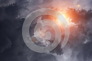 Epic dramatic storm dark grey clouds with sun and sunlight