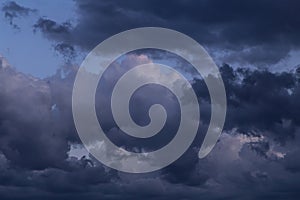 Epic dramatic storm sky with dark blue grey black cumulus rainy clouds, thunderstorm