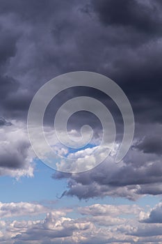 Epic dramatic Storm sky, dark grey and white cumulus clouds on blue sky background texture, thunderstorm