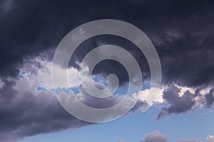 Epic dramatic Storm sky, dark grey and white cumulus clouds on blue sky background texture, thunderstorm