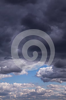 Epic dramatic Storm sky, dark grey and white cumulus clouds on blue sky background texture, thunderstorm