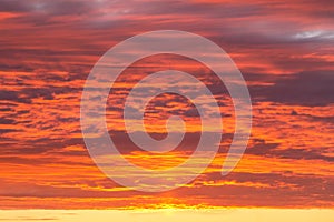 Epic dramatic sunset, sunrise orange sky with clouds and sunlight background