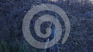 Epic Drone Aerial Shot Raising Up Over A Beautiful Waterfall in Winter time