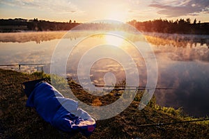 Epic photography. Fisherman at sunrise sleeping. wonderful morning scene. foggy sunrise on the lake.