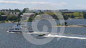 Epic shot of a speedboat passing a ferry near the coastal islands of Helsinki.