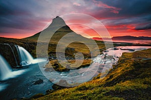 An epic sunset with Kirkjufellsfoss waterfall. Location Iceland, Europe