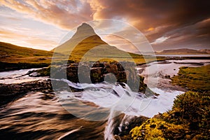 An epic sunset with Kirkjufellsfoss waterfall. Location Iceland, Europe