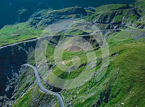 Epic winding road on Transfagarasan pass in Romania in summer time, with twisty road rising up. Road crossing Fagaras mountain