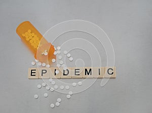 Epidemic and Bottle of Pills on Stainless Steel