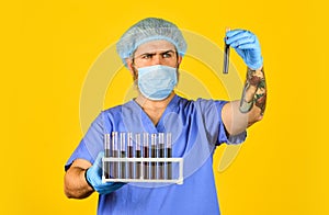 Epidemic threshold. Critical number or density of susceptible hosts. Man in medical lab inspecting samples biological