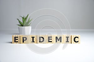 epidemic word written on wood block. epidemic text on wooden table for your desing, coronavirus concept top view