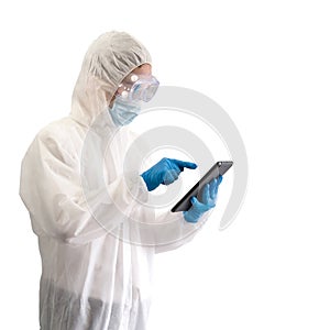 Epidemiological researcher in virus protective clothing pointing at tablet computer monitor