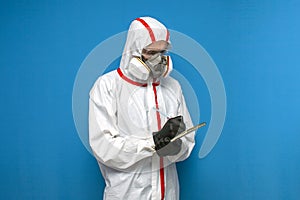 Epidemiologist in a chemical protective suit records statistics on a isolated background, man, biologist, scientist, virologist